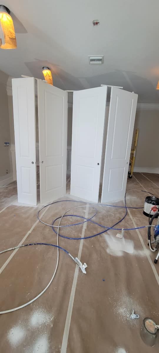 A room is being painted with white paint and a vacuum cleaner.