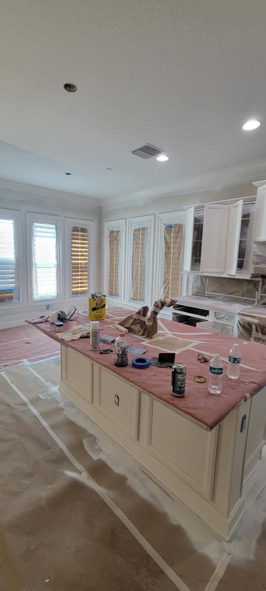A kitchen under construction with a large island in the middle of the room.