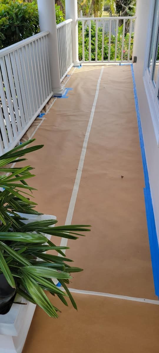 A porch with a white railing is being painted.