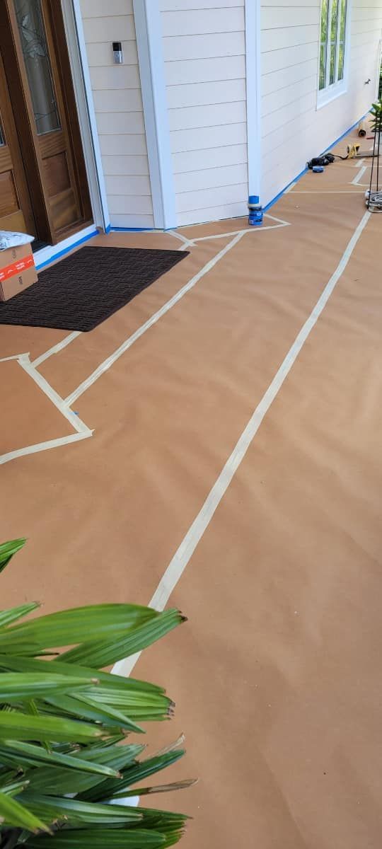 A house is being painted and covered in tape.