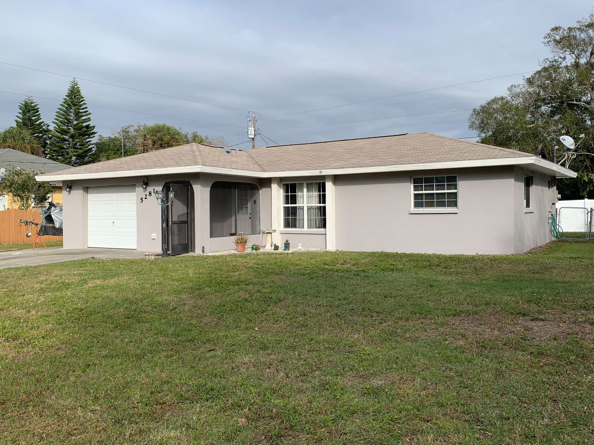 A house with a lot of grass in front of it.