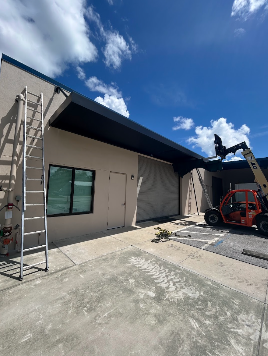 A large white building with a large lawn in front of it.
