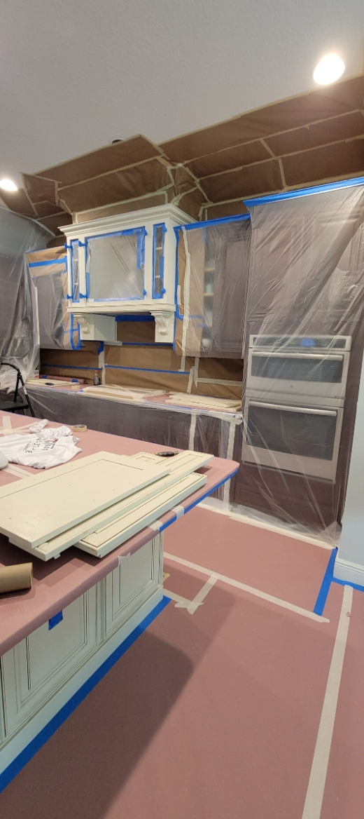 A living room filled with furniture and a fireplace with a ceiling fan.