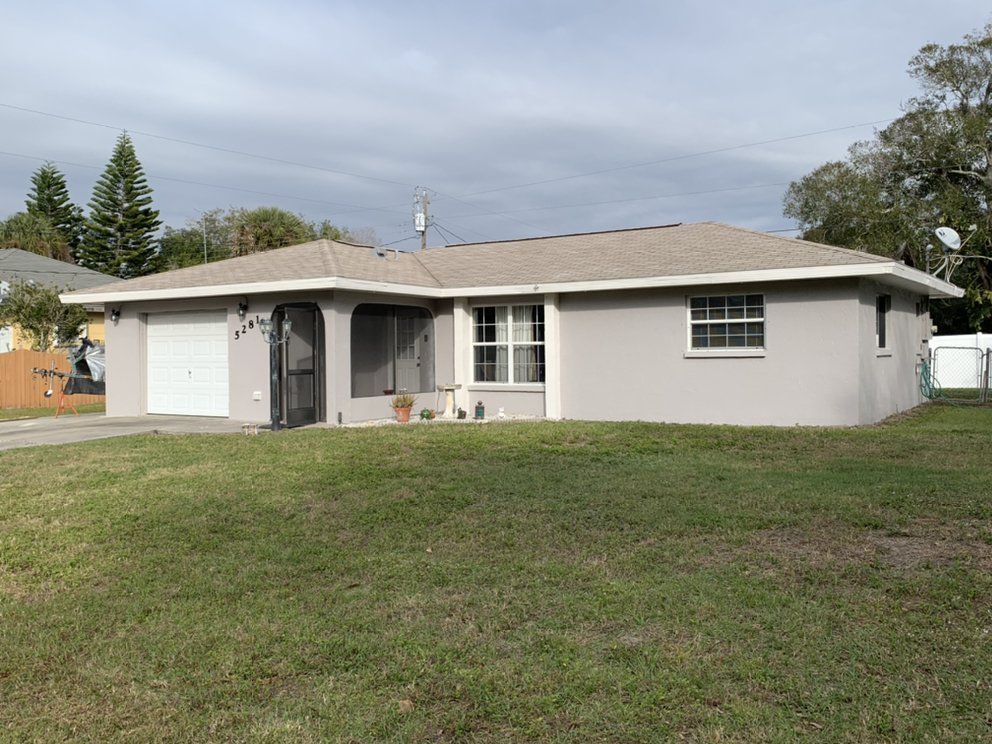 A house with a lot of grass in front of it.