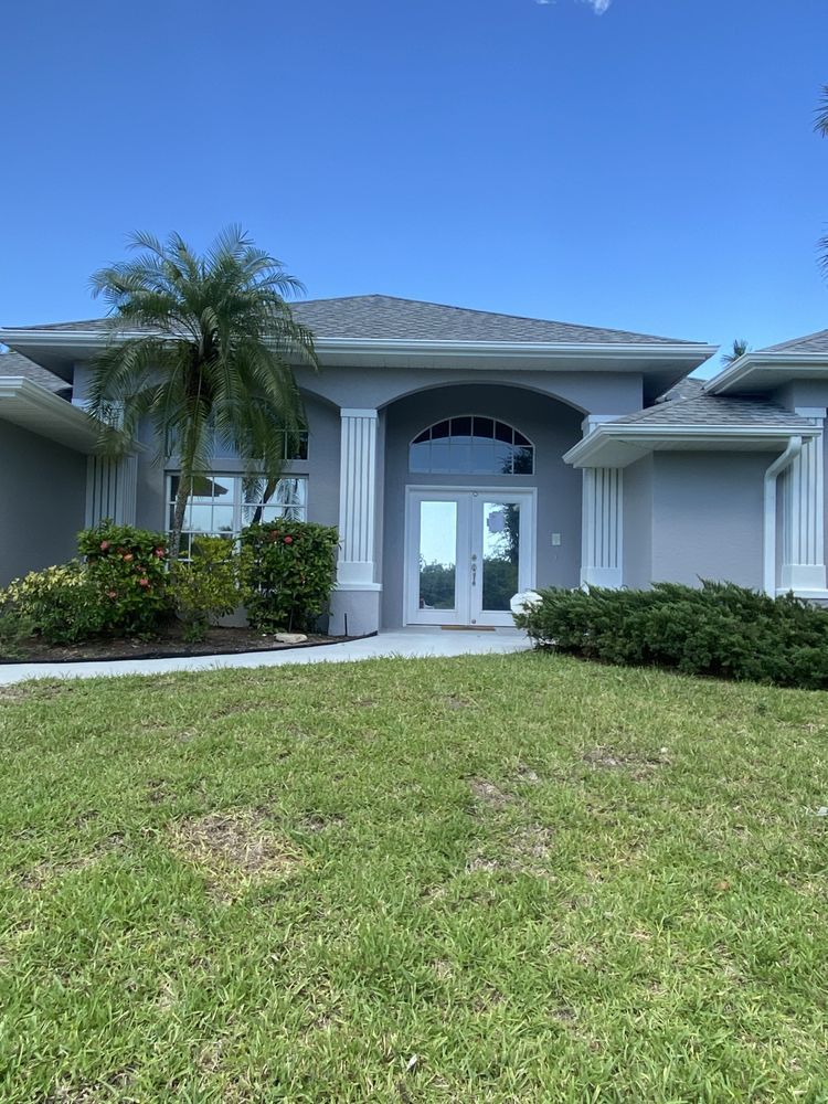 A large house with a lush green lawn in front of it.