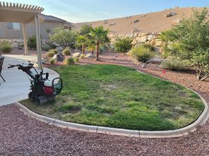 A lawn mower is parked in the middle of a lush green lawn.