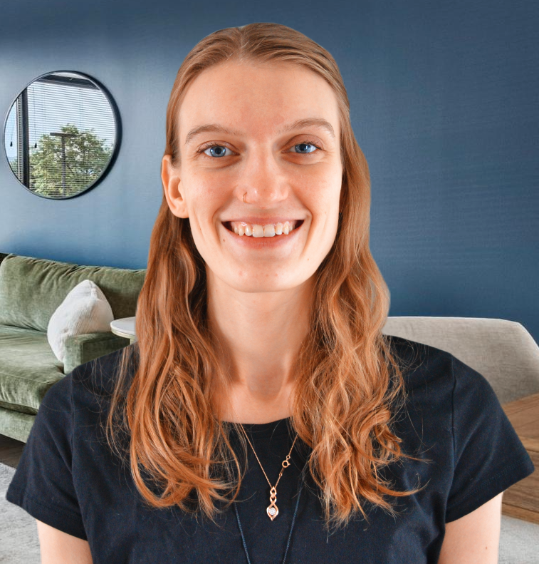 A woman wearing a black shirt is smiling in a living room