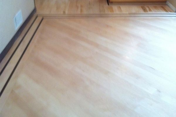 A Close Up Of A Wooden Floor In A Room