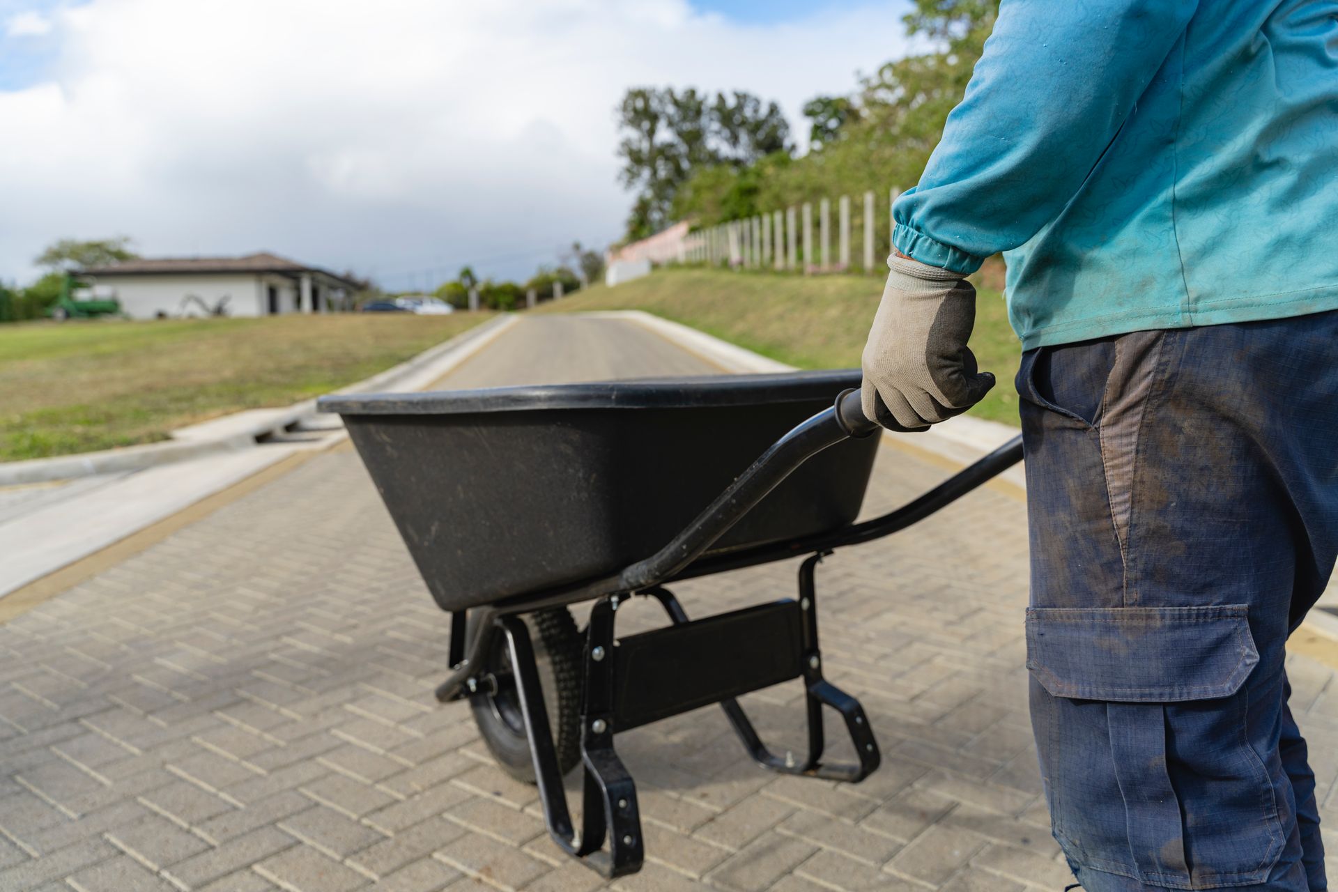 Two construction workers in a building under renovation shake hands and smile while facing each other.