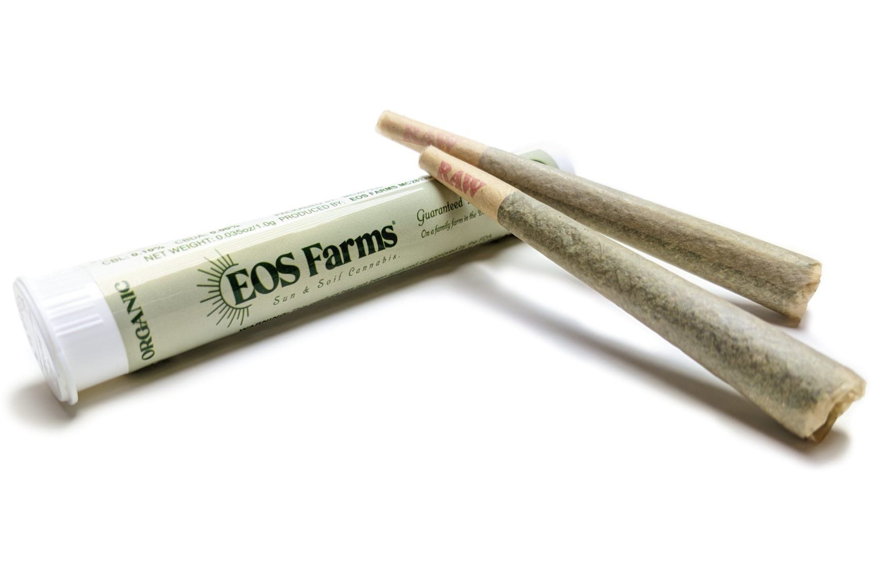 A tube of eos farms pre rolled joints on a white surface.