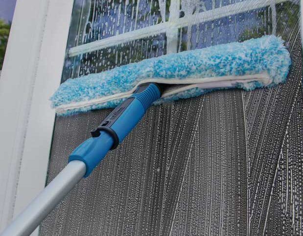 Pressure washing siding of house