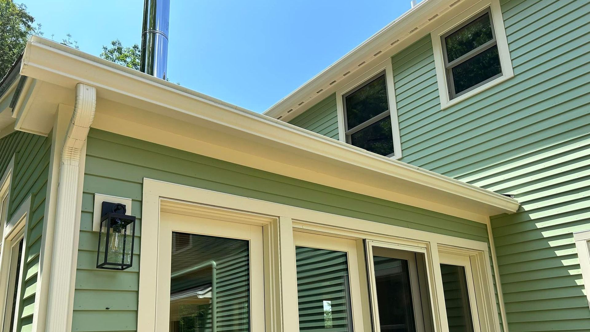 A mint green Vermont home with beautiful complementary seamless rain gutters installed by SNJ Seamless