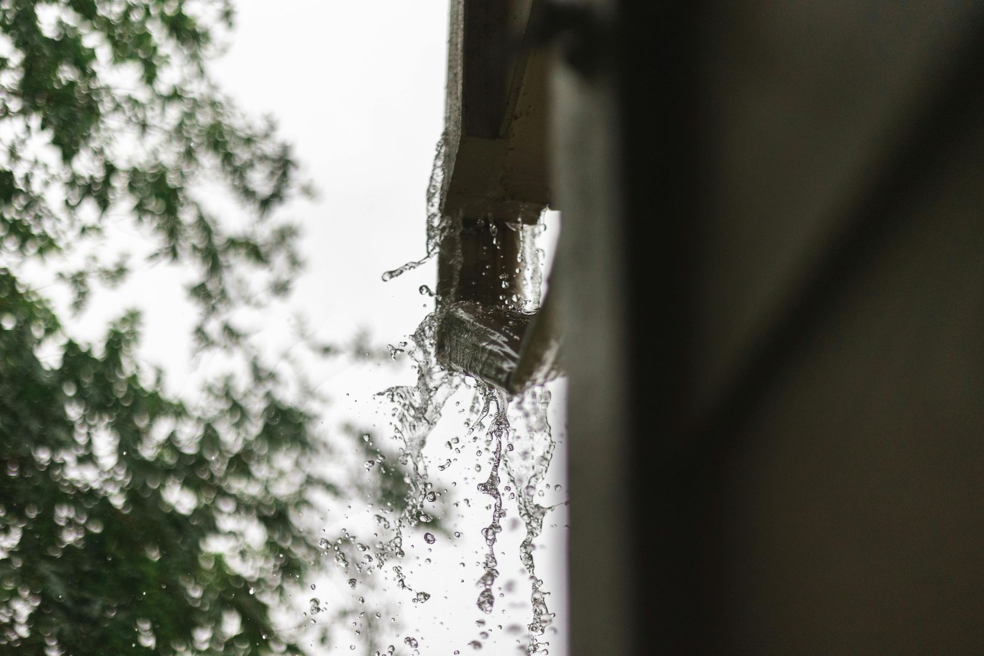 An overwhelmed rain gutter overflows in Vermont