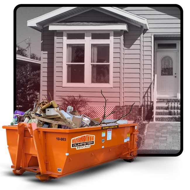 A 757 dumpster in front of a house