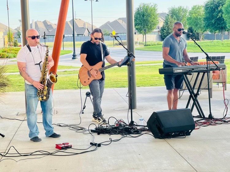 A group of men are playing instruments and singing on a stage.