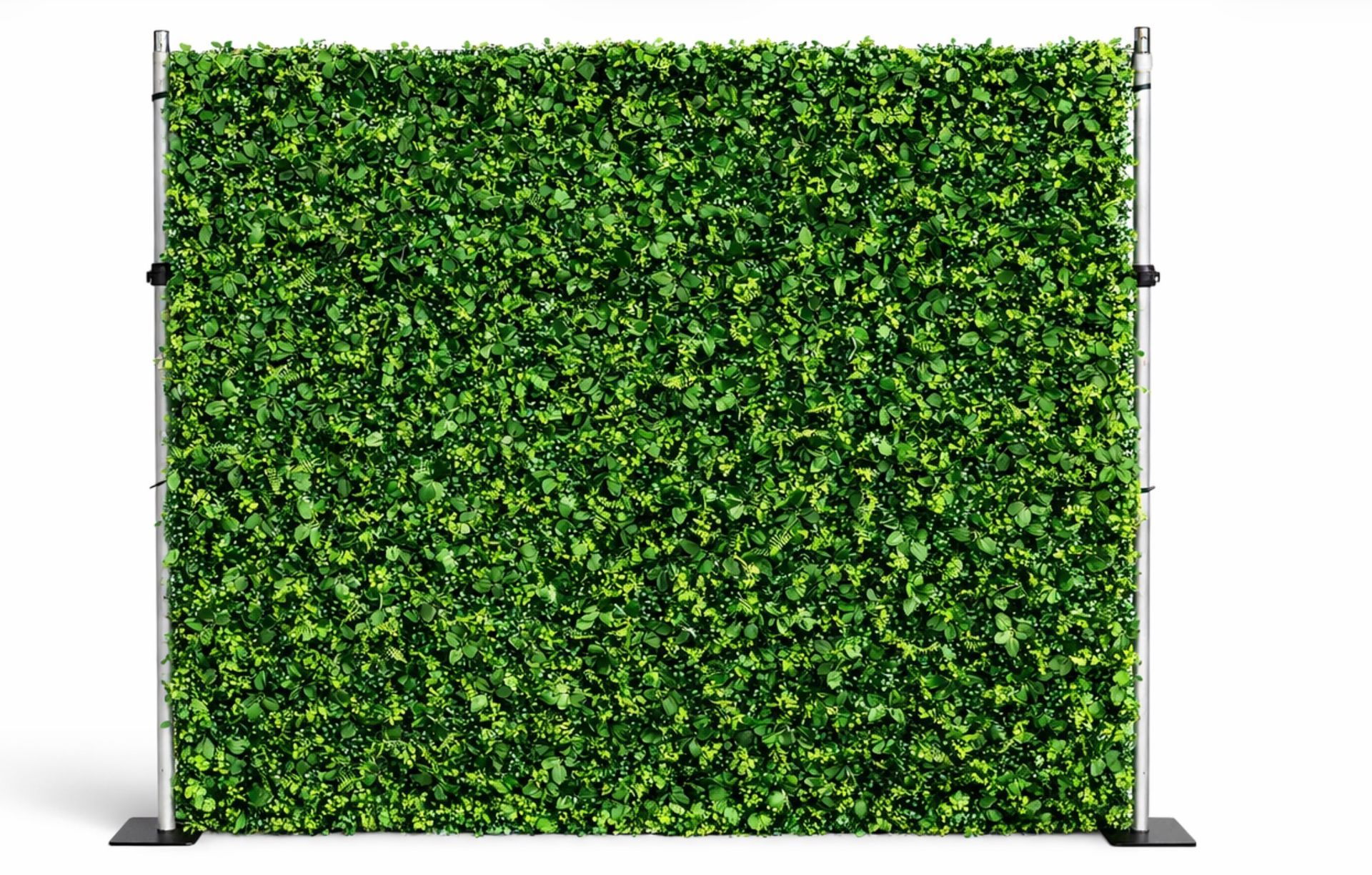 Lush green foliage wall backdrop with mixed faux leaves, mounted on a freestanding metal frame against a clean white background.