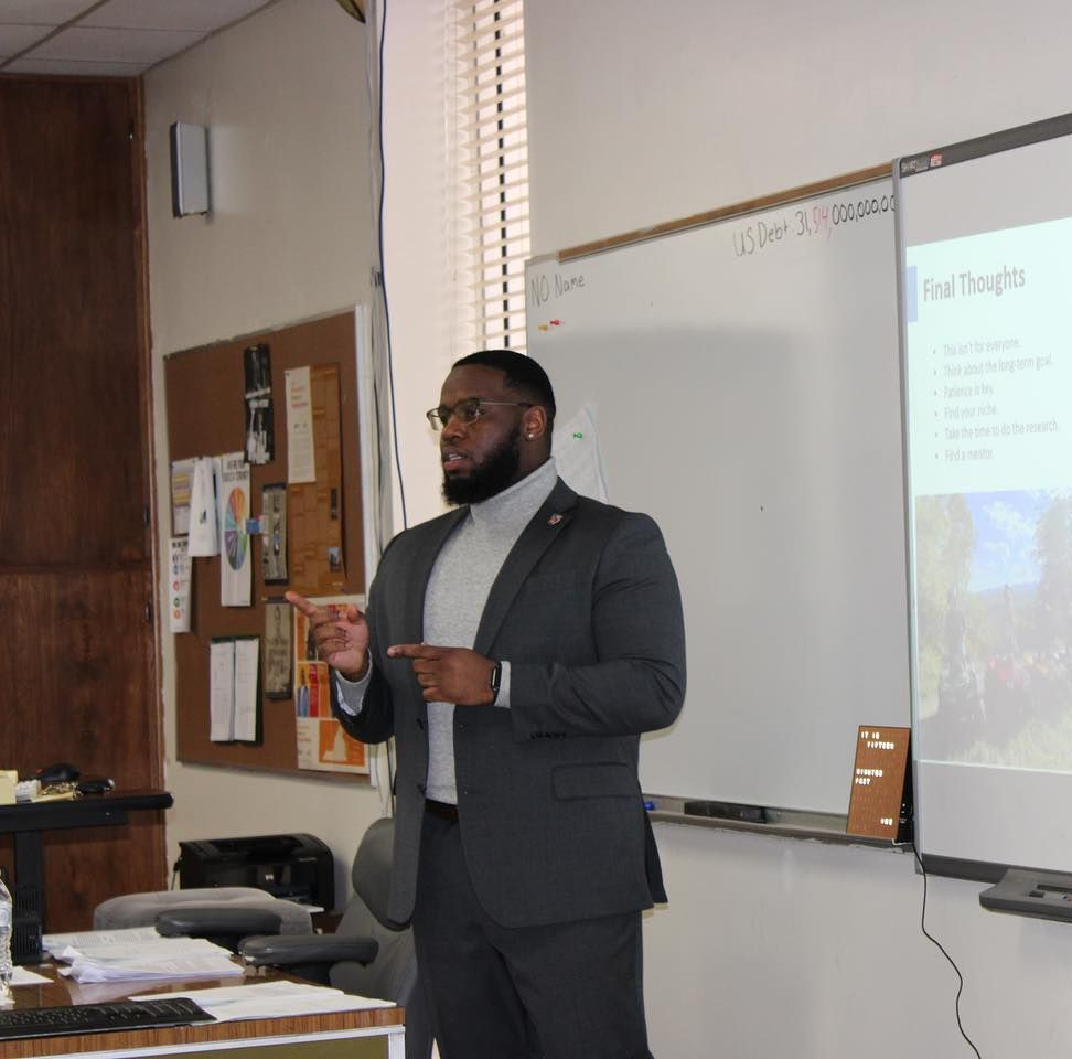 A white truck is parked in a parking lot next to a building.