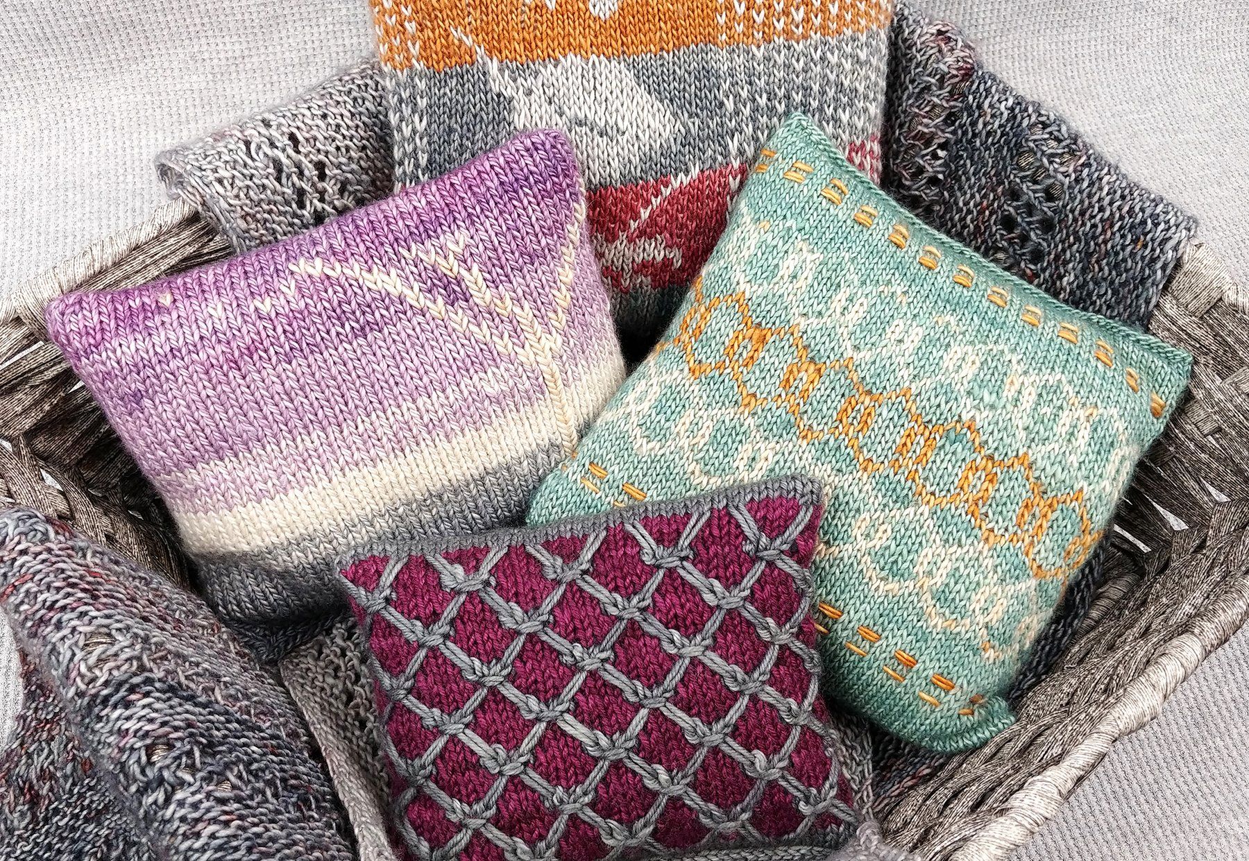 basket of knitted yarnsketch pillows made by debi martin of blue skin yarns