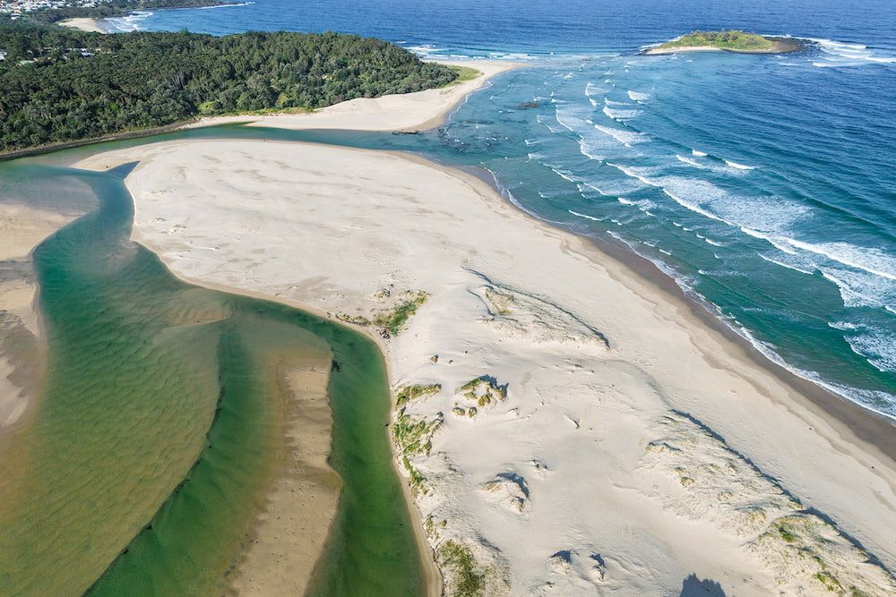 Aerial View: Sandy River Delta Meets Ocean. Green River, White Sand, Blue Ocean — SeaChange Parks Milton in Lake Conjola, NSW