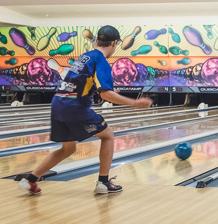 Boy in Blue Bowling Uniform, Bowling Ball Rolling Down the Lane in Front of a Colourful Backdrop — SeaChange Parks Milton in Milton, NSW