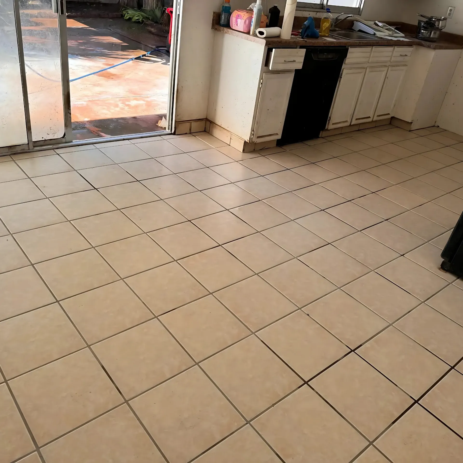Clean Dry Carpet Care - A kitchen with a tiled floor and a sliding glass door