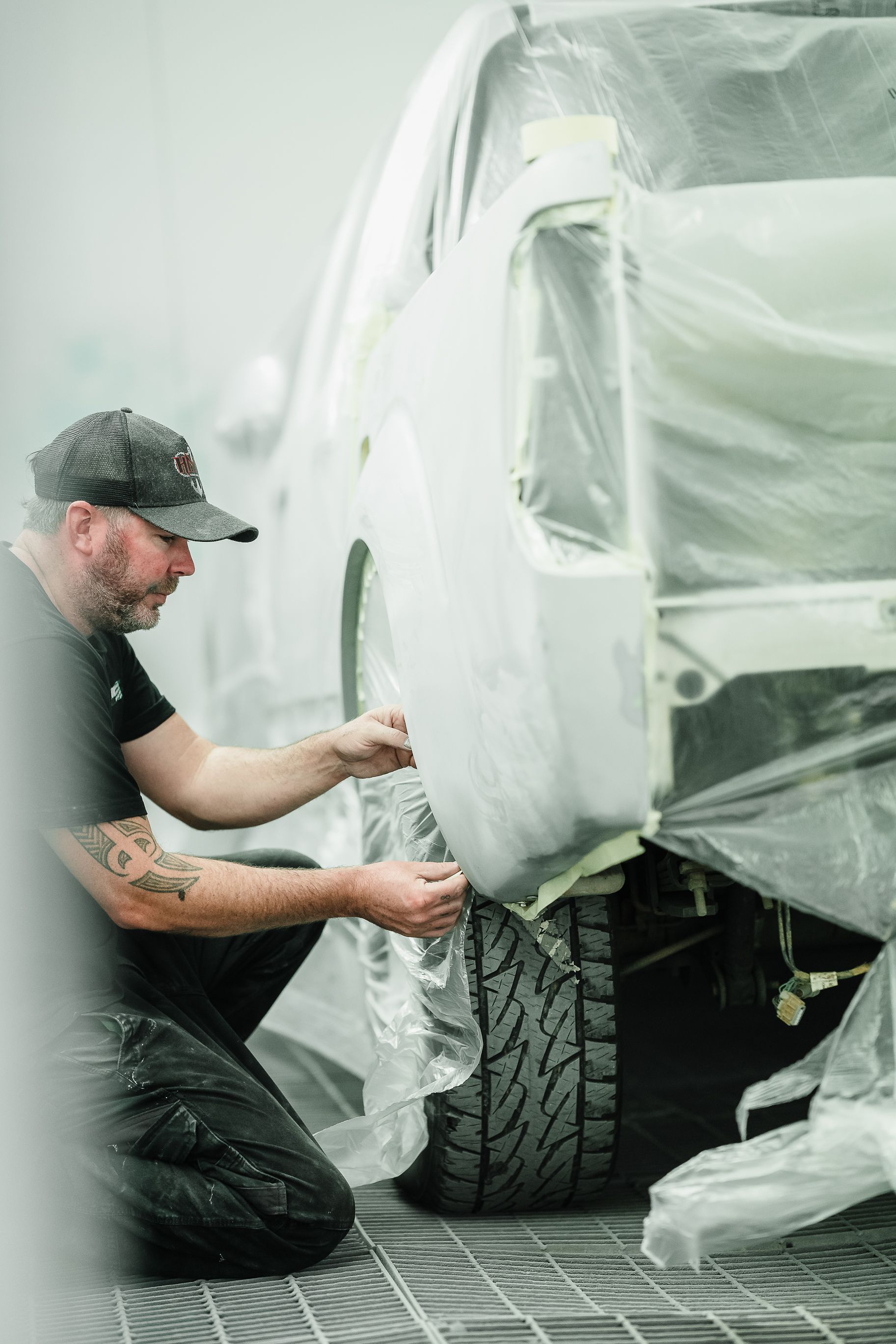 Man Covering the Car with Plastic — Kingborough, TAS — Kingston Panel & Paint