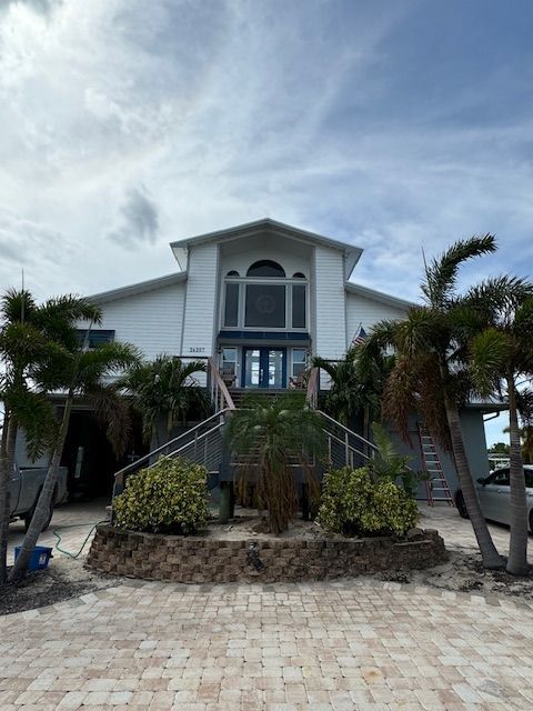 A large white house with palm trees in front of it
