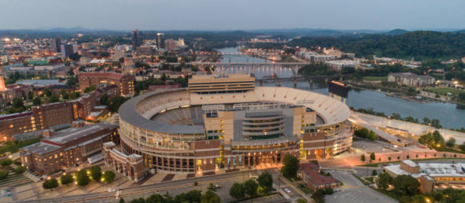 An aerial view of a small town with mountains in the background.