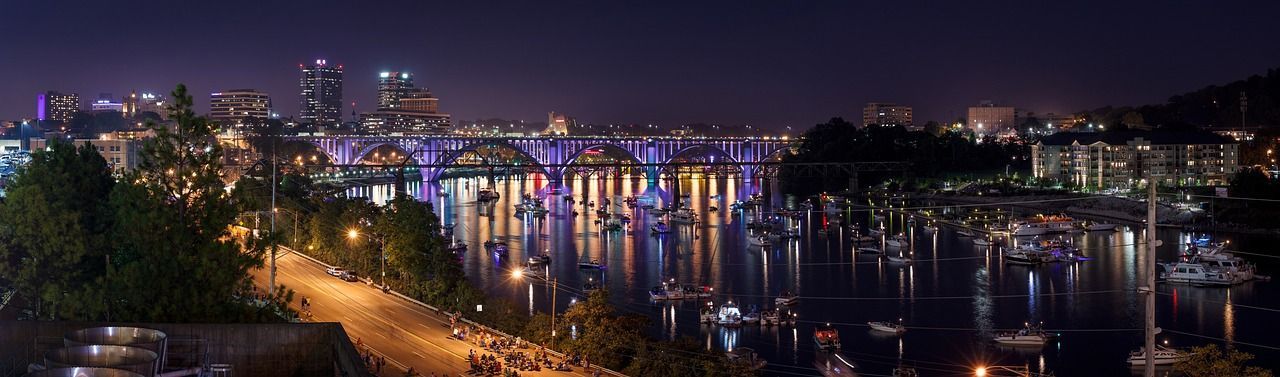 A blurry picture of a city at night with boats in the water.