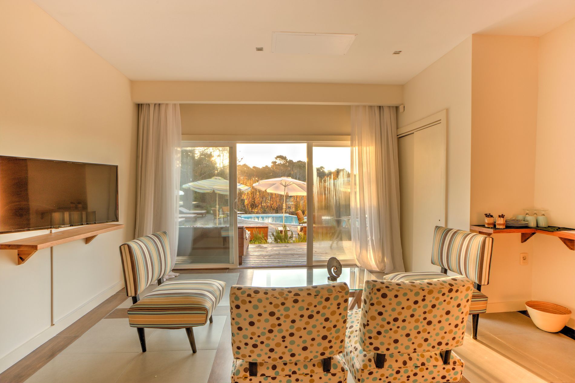 Una sala de estar con una gran puerta corrediza de vidrio y un televisor de pantalla plana.