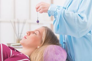 Therapist using pendulum - Hypnosis & Reiki Services - Lawrenceville, New Jersey