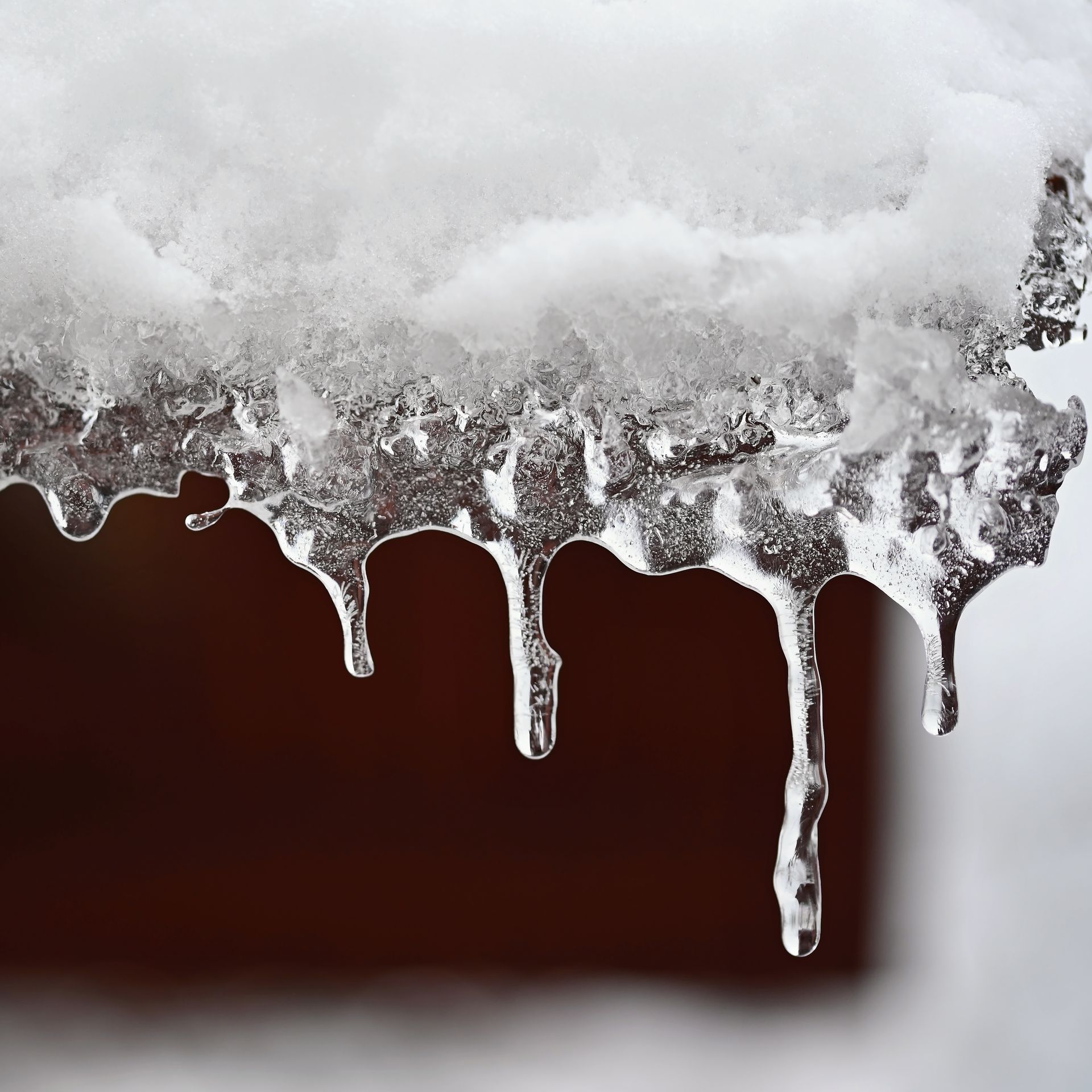 A close up of icicles dripping from a roof