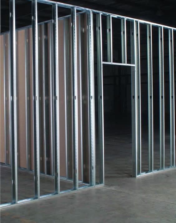 A room with a lot of metal frames on the wall