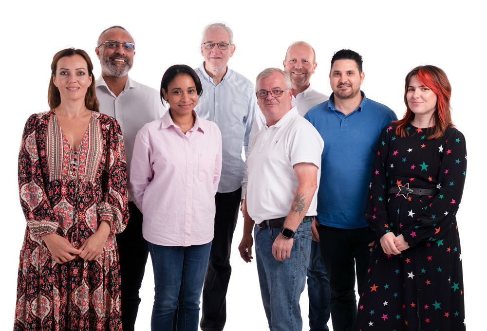 A group of people standing next to each other on a white background team from VMG