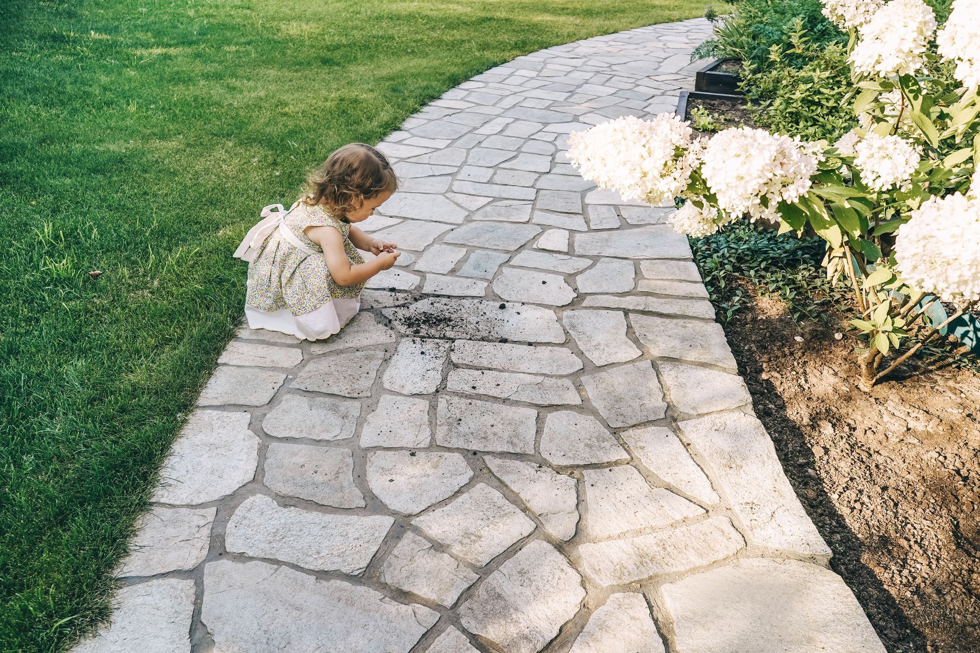 A model house with a black roof and a porch on a white background.