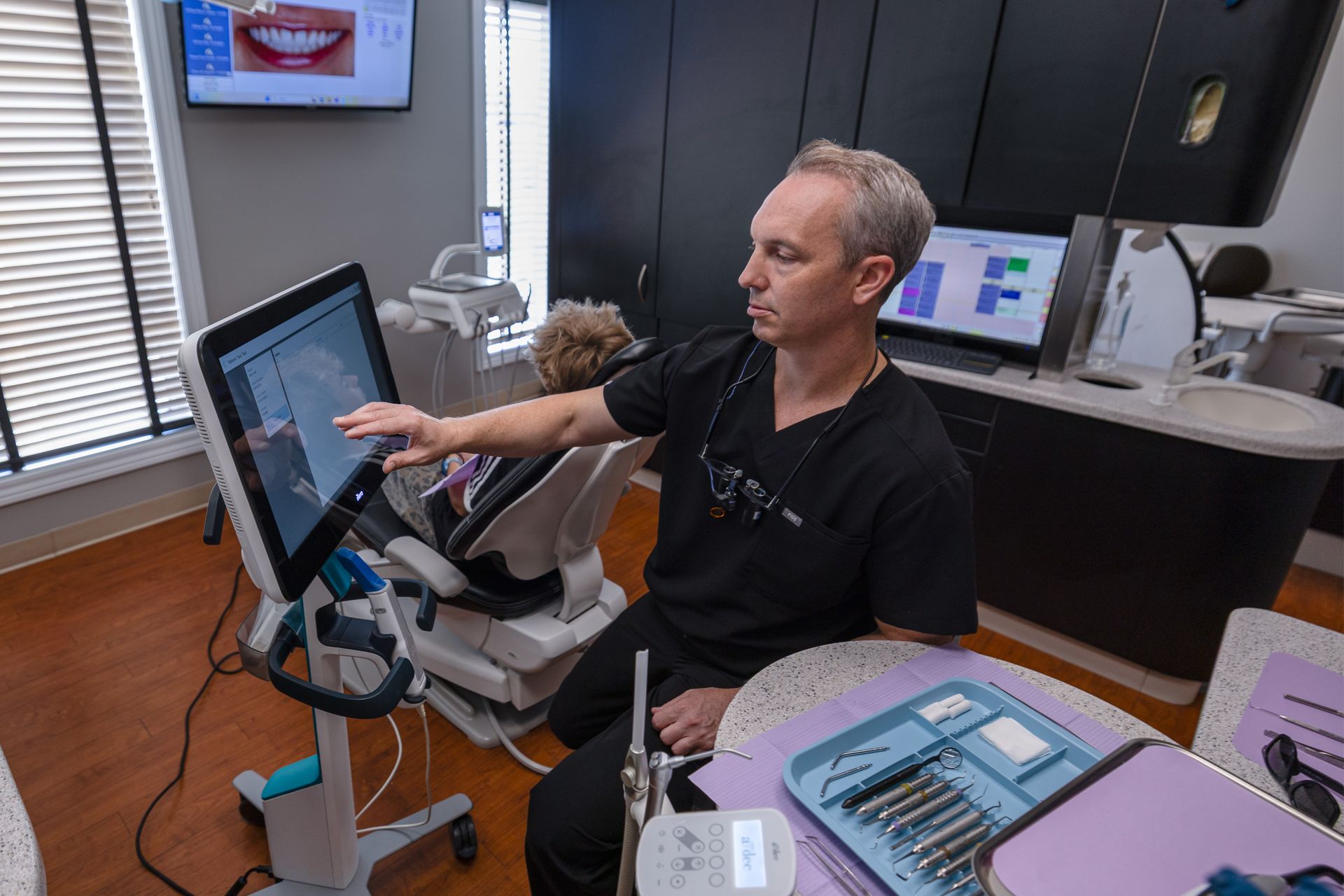 Dentist using the iTero Scanner with patient in chair