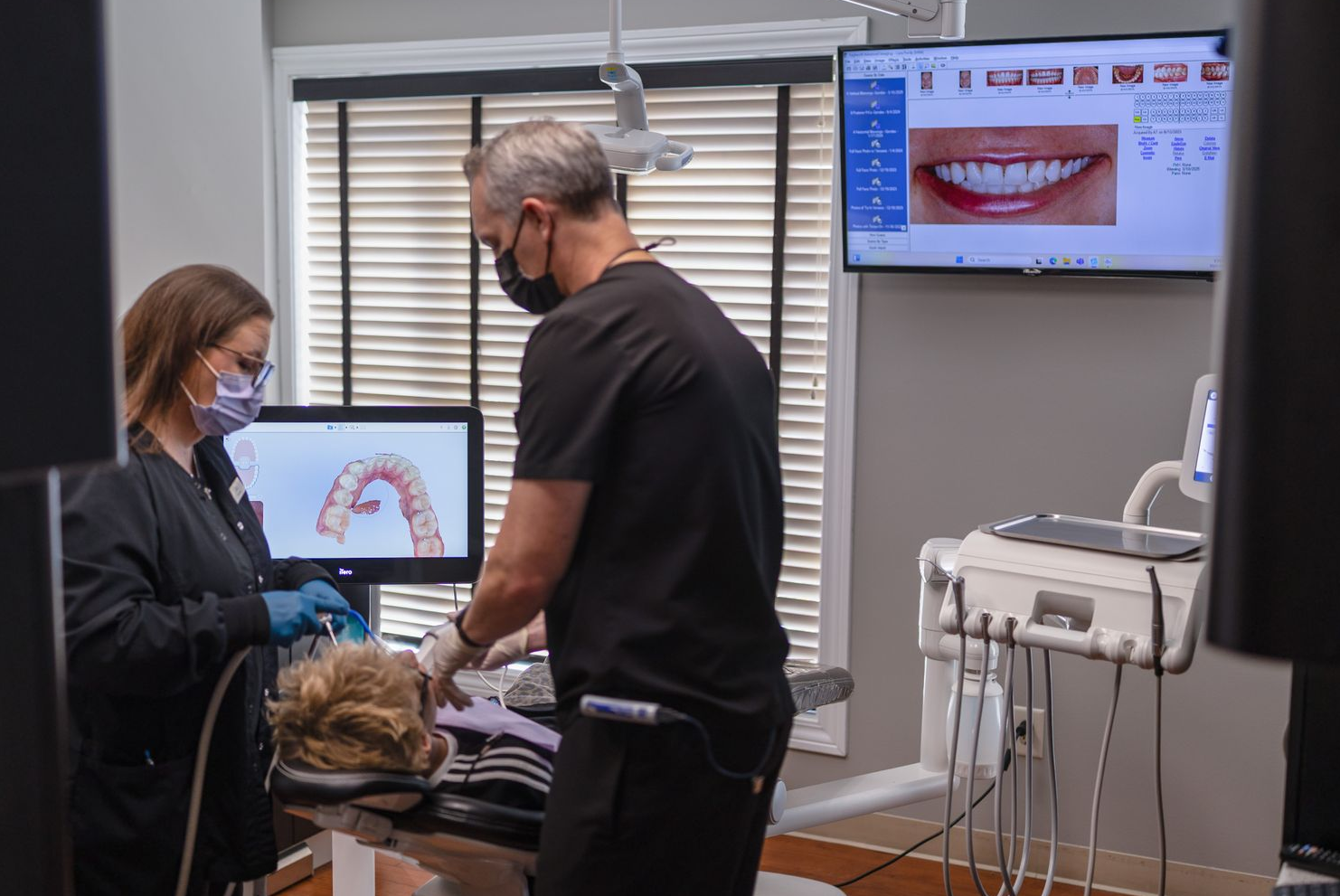 Dentist and assistant work on patient using the iTero Scanner