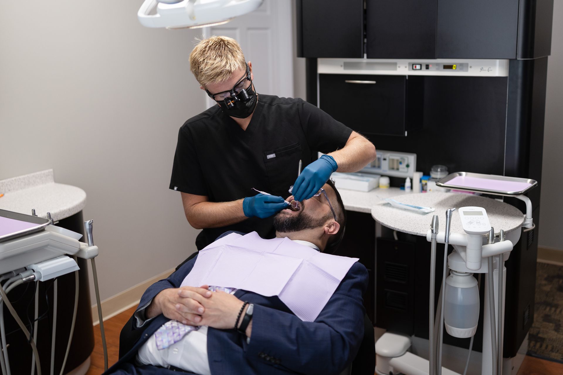 A man lying in a dental chair getting his teeth checked