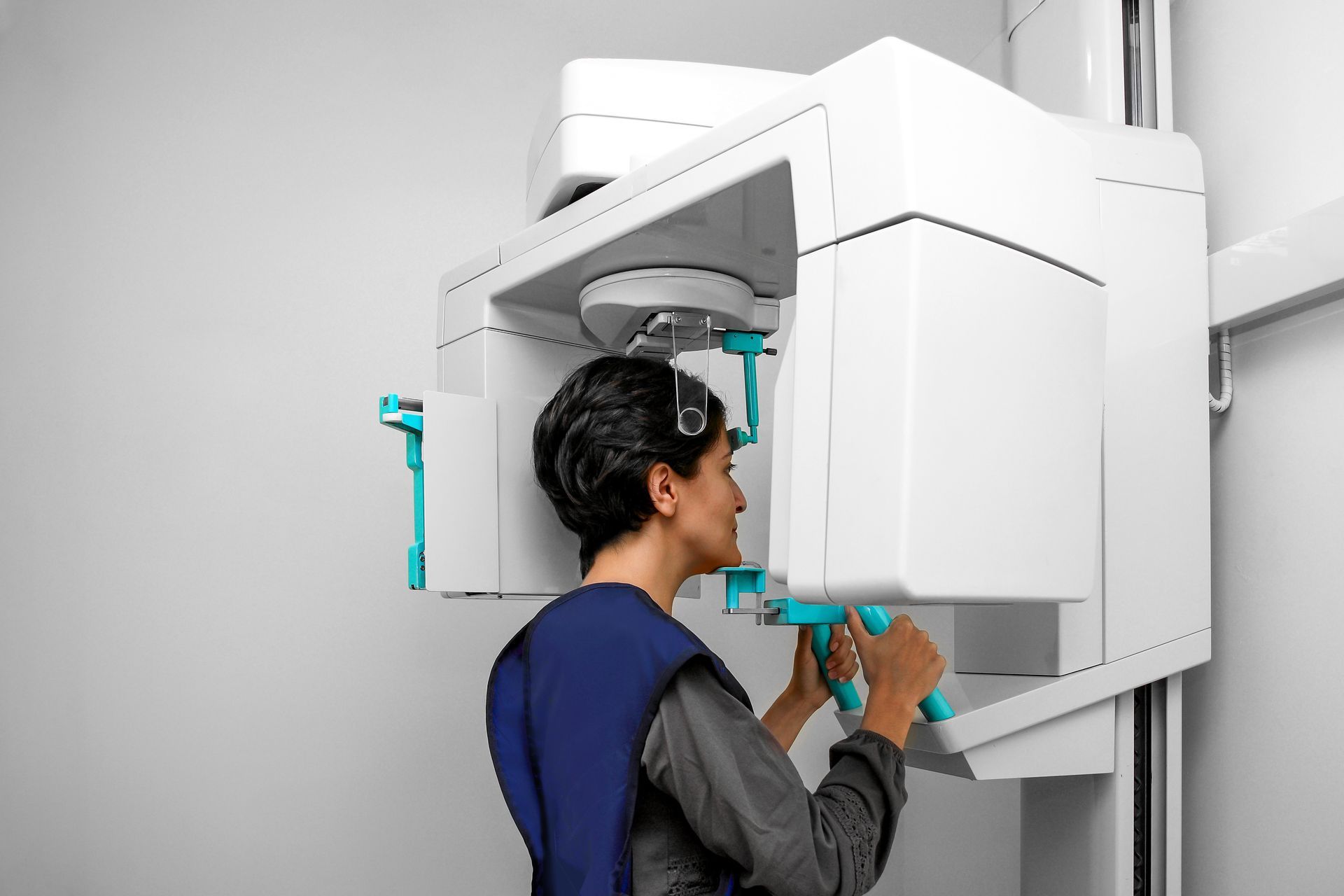 A man is getting an x-ray of his teeth in a dental office.