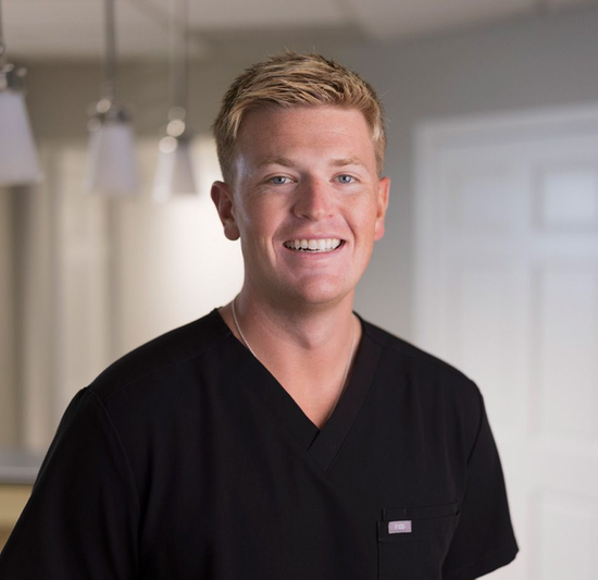 Andrew DDS in a black shirt is smiling for the camera