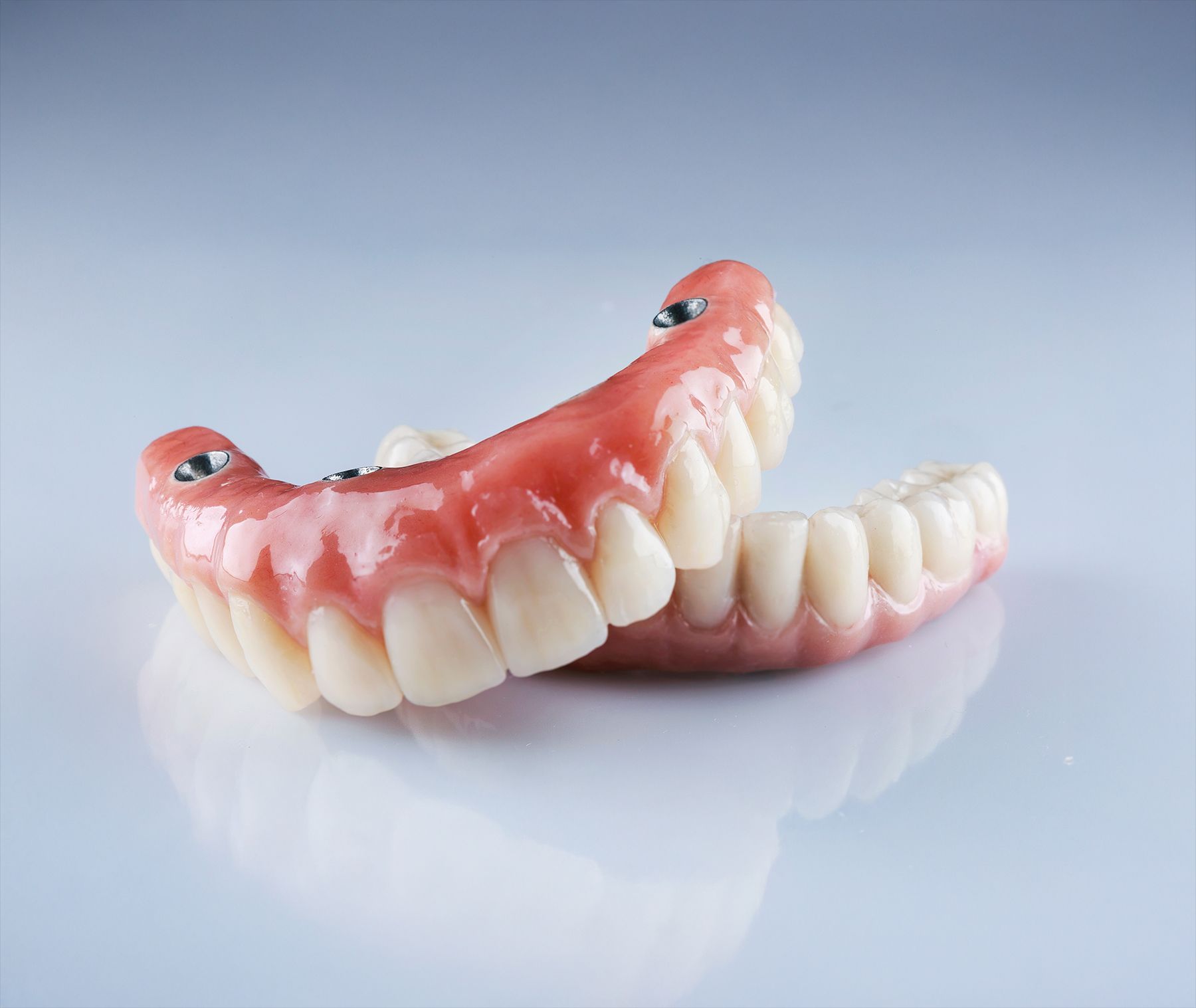 A close up of a full denture on a table.