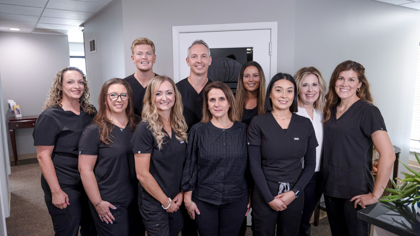 A group of people standing next to each other in a dentist office