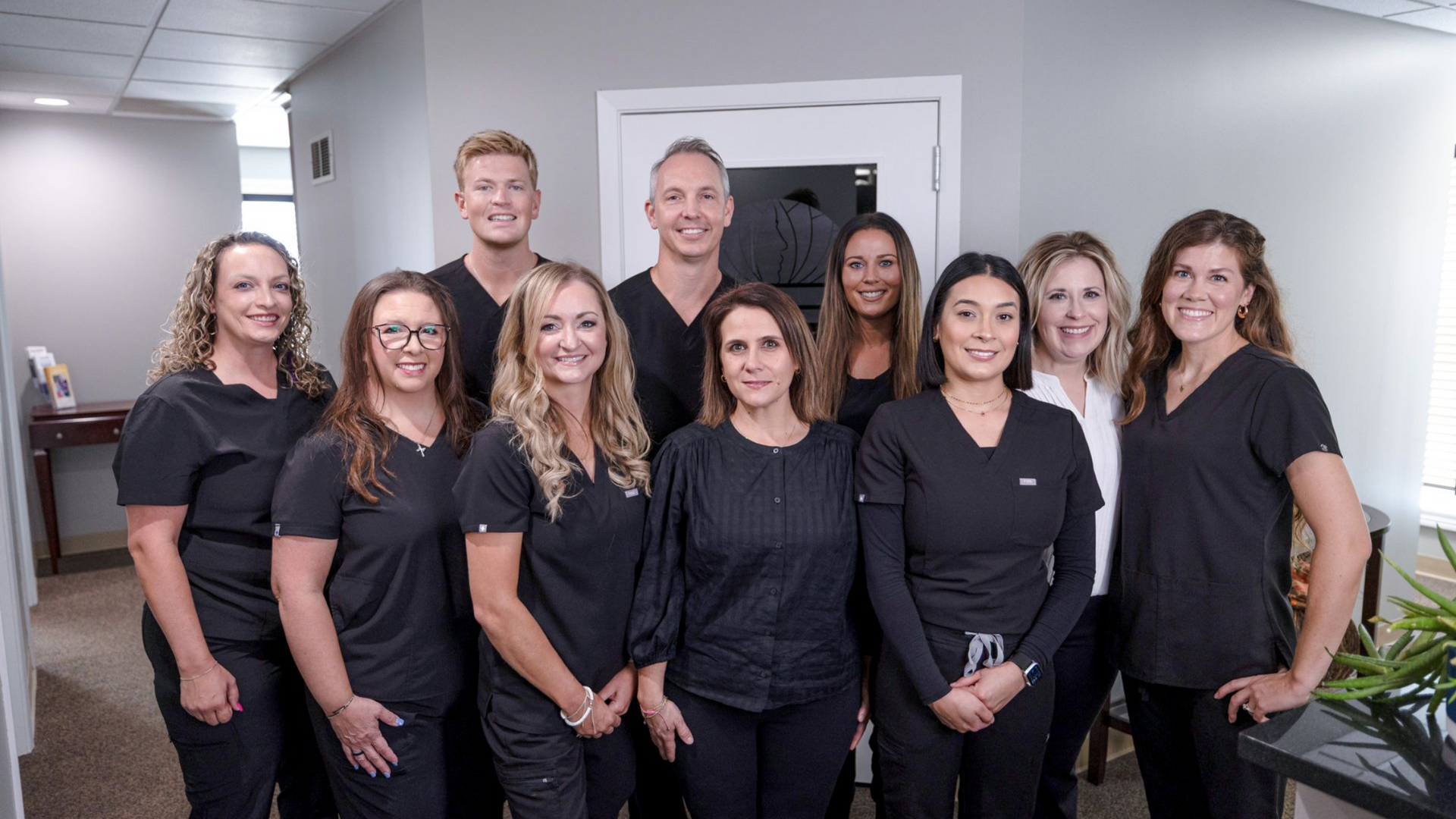 A group of people standing next to each other in a dentist office
