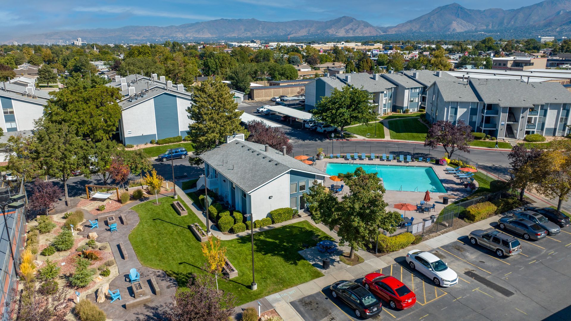 a living room with a couch , chair , coffee table and dining room in the background .