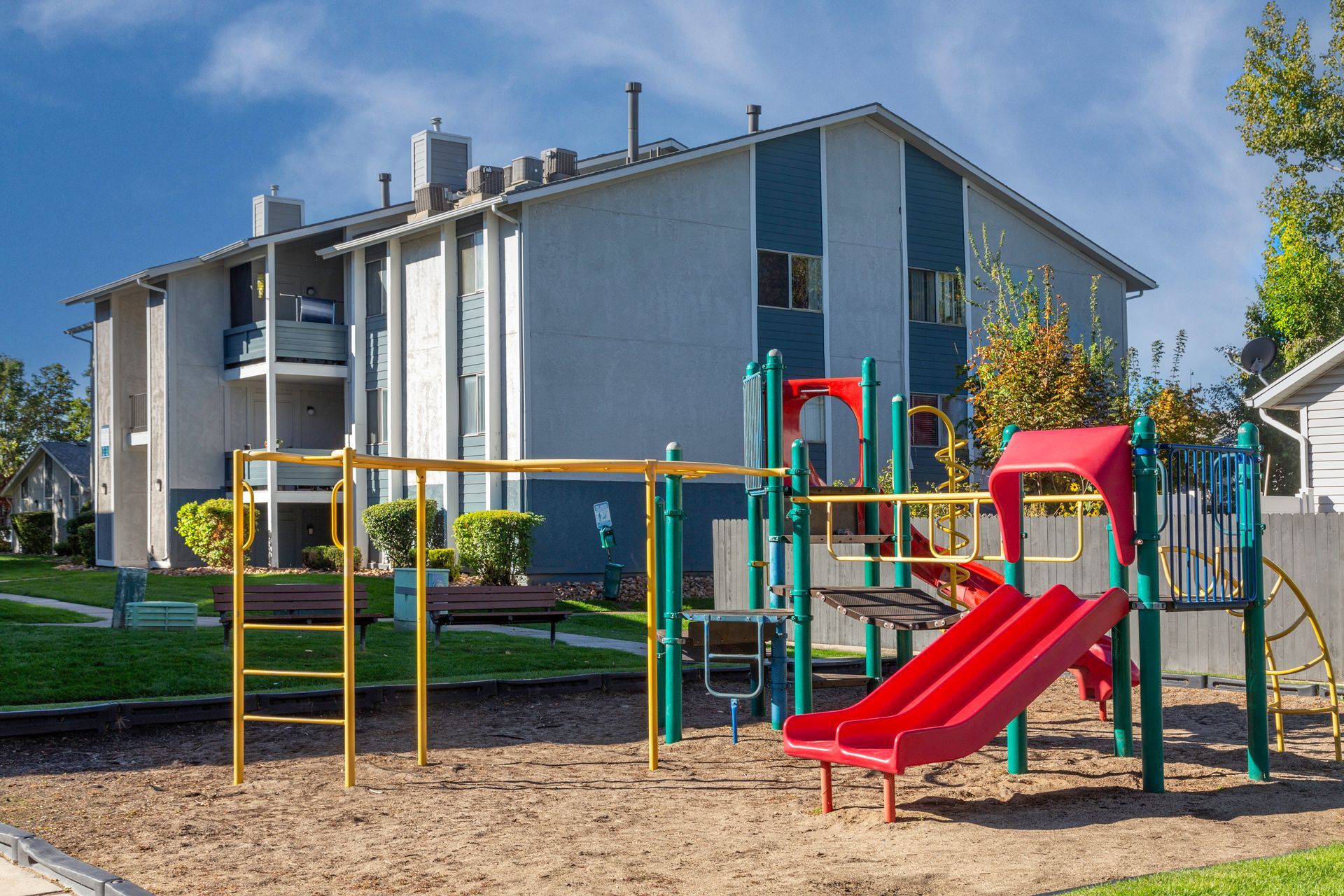 a playground with a slide in front of a building
