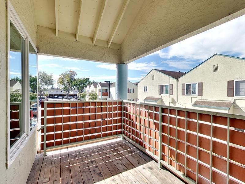 a balcony with a brick fence and a window