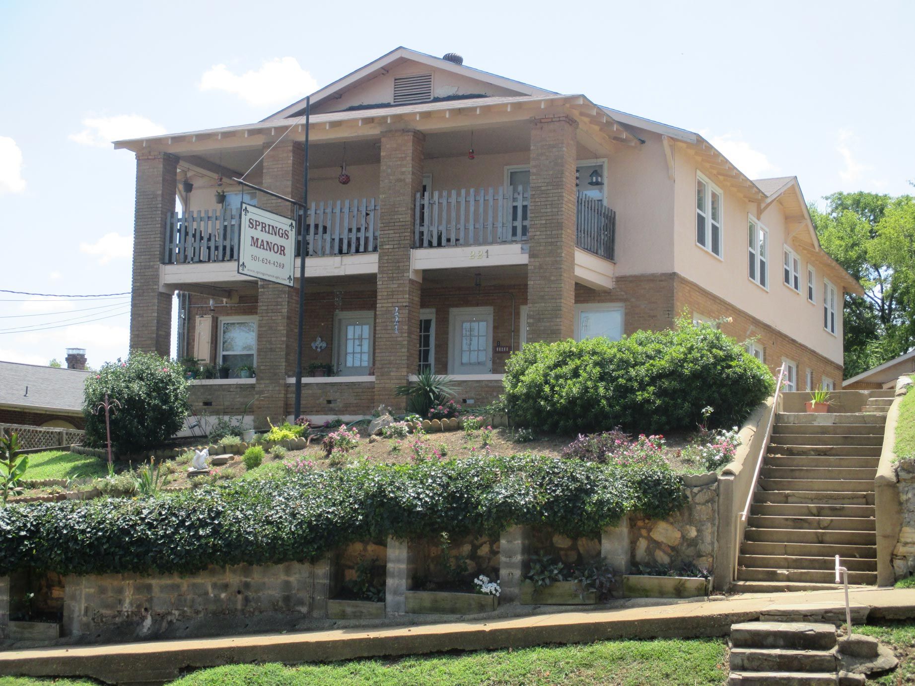 A large house with stairs leading up to it