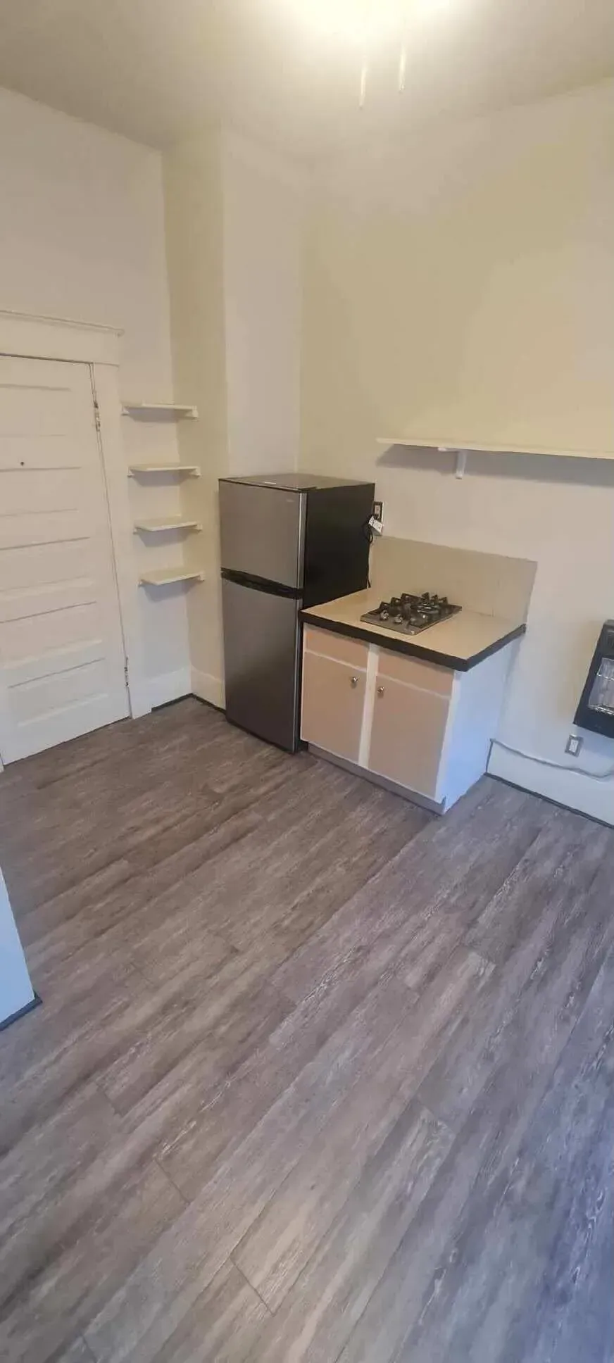 A kitchen with a refrigerator , stove , and sink.