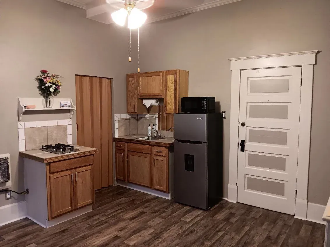 A kitchen with a refrigerator , stove , sink and microwave.