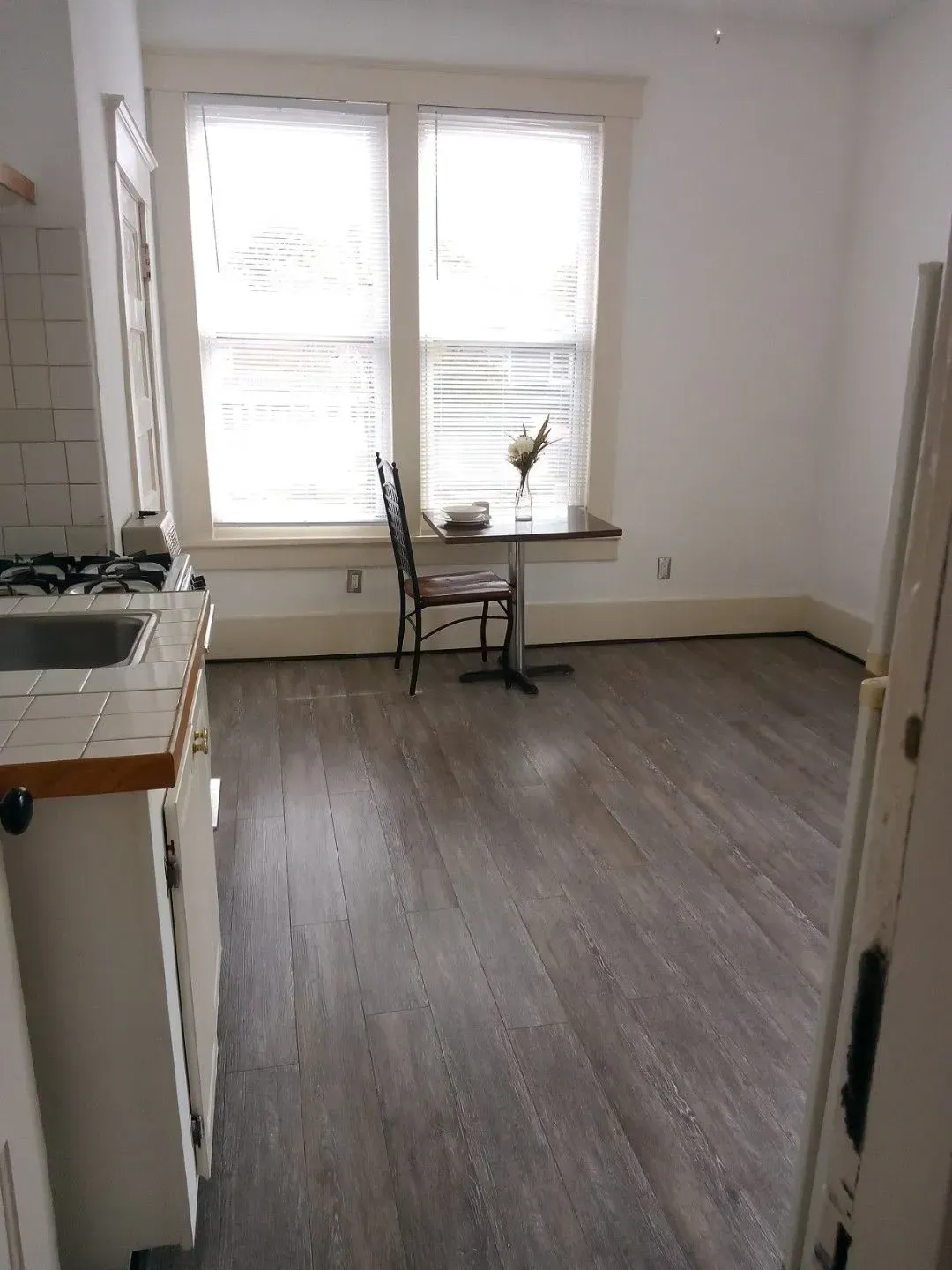 A kitchen with a table and chairs in it